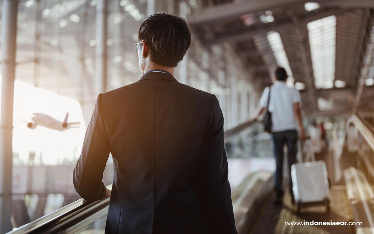 Business professional at airport representing visa and work permit services in Indonesia